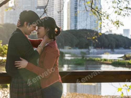 Preview: Romantic LGBT couple of young women touching foreheads and noses while gazing at each other