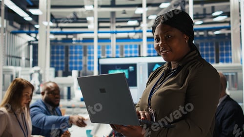 Preview: Happy solar panels facility engineer using laptop to improve efficiency