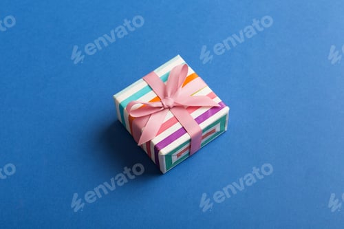 Preview: wrapped Christmas or other holiday handmade gift box in color paper with ribbon