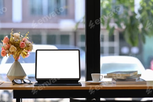 Preview: Mock up digital tablet with wireless keyboard, coffee cup and pot of rose flower on wooden table.