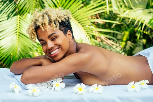 Preview: attractive african american female get treatment massage in tropics resort outdoor salon