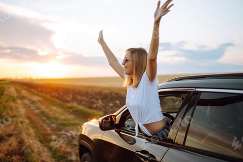 Preview: Lifestyle! Tourist woman rests and leans out of car window, enjoys trip. Travel concept, vacation.