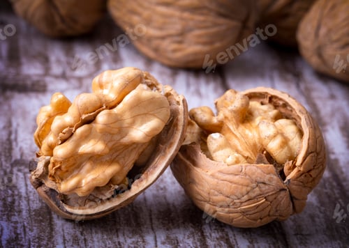 Preview: Walnuts on dark vintage table, Walnuts kernels in wooden bowl. Walnut healthy food