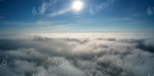 Preview: Aerial view from high altitude of earth covered with puffy rainy clouds forming before rainstorm
