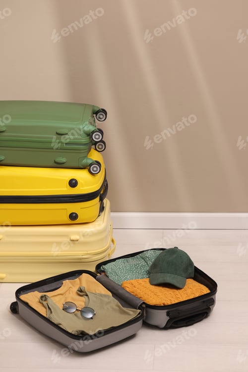 Preview: Suitcase with female clothes and accessories on white blanket. Vacation and travel concept.