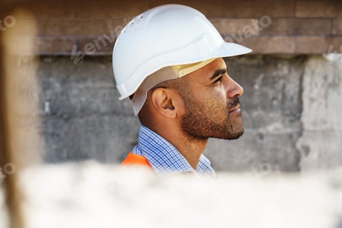 Preview: Portrait of young construction engineer wearing hardhat