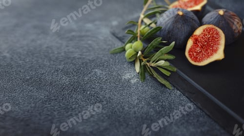 Preview: fresh ripe figs fruit and olive branch on dark table