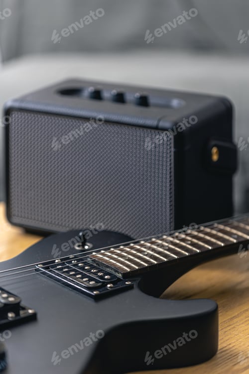 Preview: Black electric guitar and speaker close-up. Guitar amplifier, musical equipment.