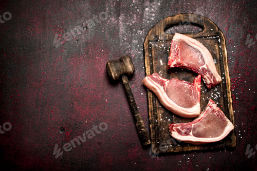 Preview: Raw meat background. Raw pork is with the old hammer.