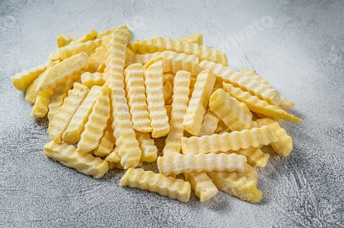 Preview: Frozen Crinkle French fries potatoes sticks. White background. Top view