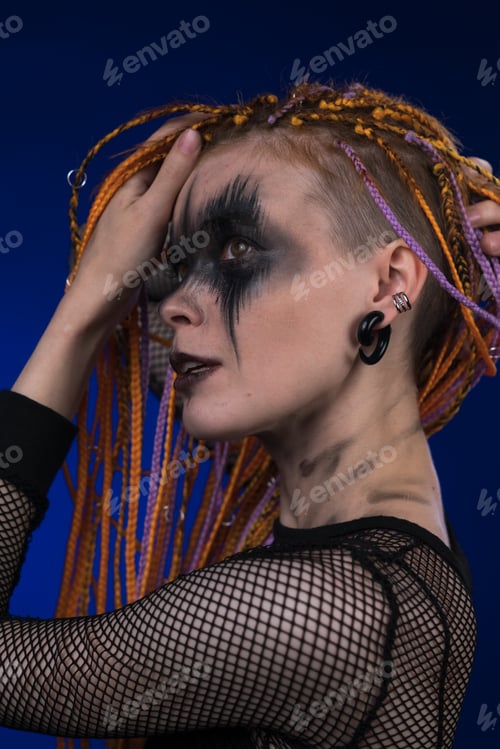 Preview: Beautiful adult female with dreadlocks hairstyle, creative horror black stage makeup painted on face