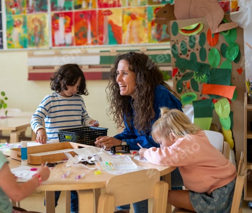 Preview: Happy encouraging teacher speaking to her class, young group of children listening to their lesson