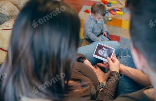 Preview: Parents looking ultrasound of their new baby