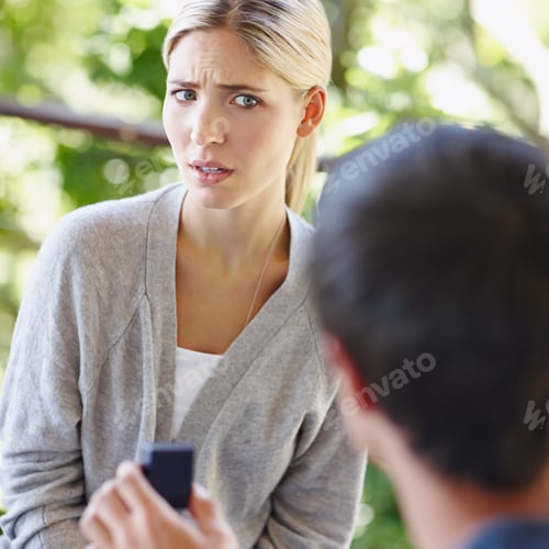 Preview: Shot of a beautiful young woman looking uncertain as her boyfriend is proposing