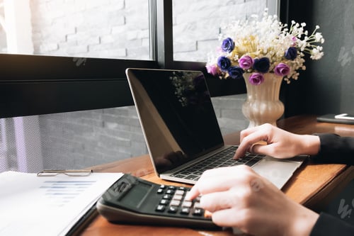 Preview: Business using laptop computer with calculator on office desk.
