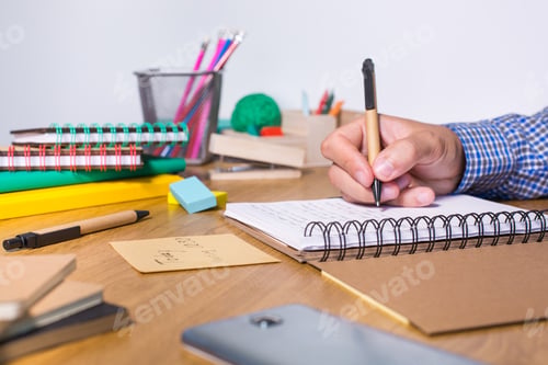Preview: Young man sitting at the table and studying from home