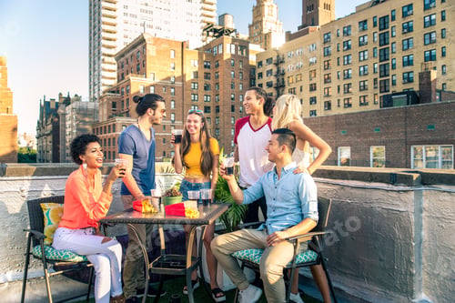Preview: Group of friends having party on a rooftop
