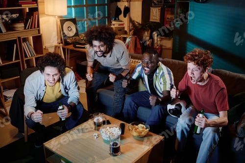 Preview: Young Men Watching Soccer Gamer On TV