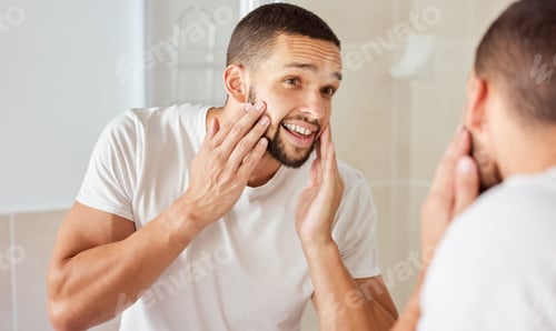 Preview: Shot of a young man admiring his face in the bathroom mirror