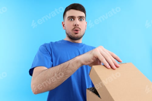 Preview: Concept of delivery, surprise, gift, young man opened a cardboard box
