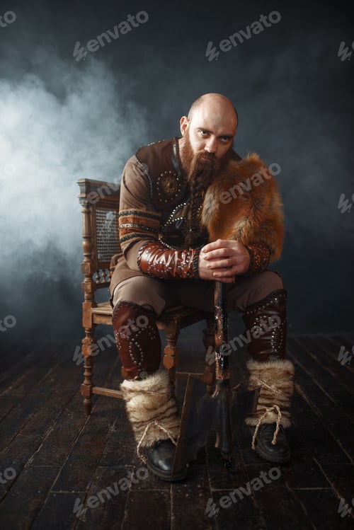 Preview: Bearded viking with axe sitting on chair