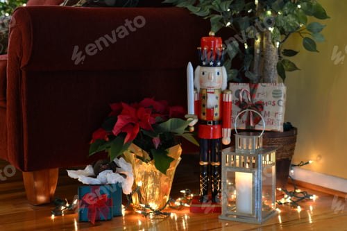 Preview: Christmas display of a Nutcracker, poinsettia, presents gifts, candle lantern with white lights.