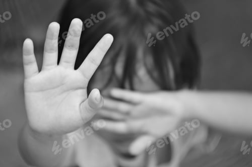 Preview: Grayscale shot of a child stopping with his hand