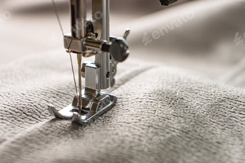 Preview: Modern sewing machine and gray fabric. Sewing process, handmade, hobby, DIY, business, repair