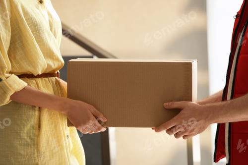 Preview: Woman receiving parcel from deliveryman on blurred background, closeup. Space for text