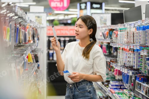 Preview: young woman enjoying shopping at department store.