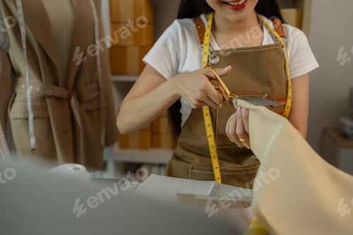 Preview: a beautiful tailor is working on her favorite craft in a studio filled