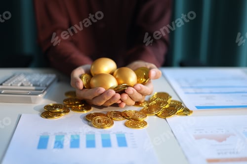 Preview: Gold coins and golden eggs in businessman’s hands. Financial growth and investment concept