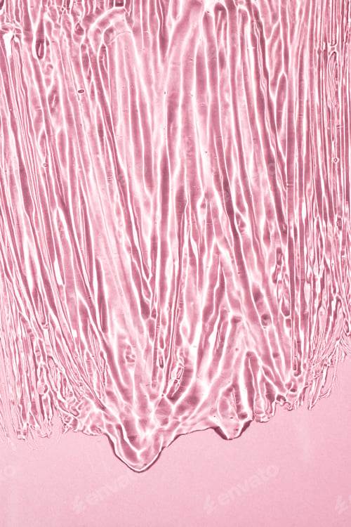 Preview: Transparent liquid gel texture on pink background. Close-up, top view.