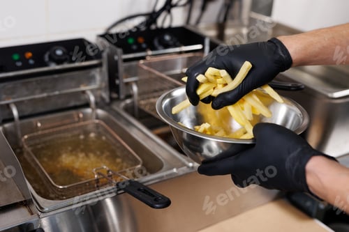 Preview: The cook is cooking French fries. Frying potatoes in fryer for French fries.