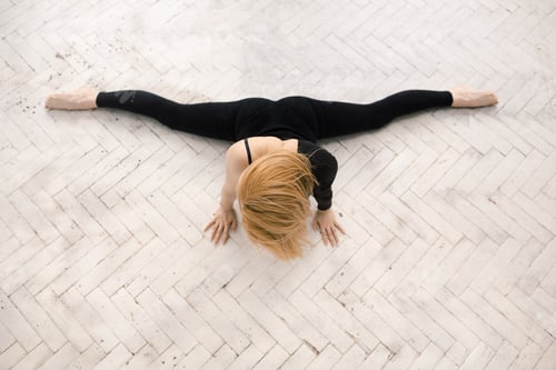 Preview: Young attractive female fitness woman performing a twine