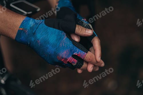 Preview: Close up of man in sport gloves leaning on bike handlebar