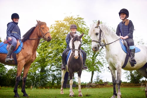 Preview: Lets get ready to ride. Shot of a group of teenage girls going horseback riding together.