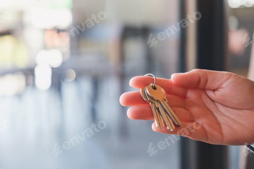 Preview: Closeup image of a hand holding the keys for real estate concept