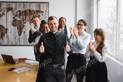 Preview: Successful creative multiracial business team giving high five.