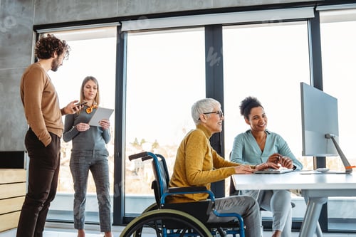 Preview: The image includes a person using a wheelchair, depicting inclusivity and teamwork in modern office
