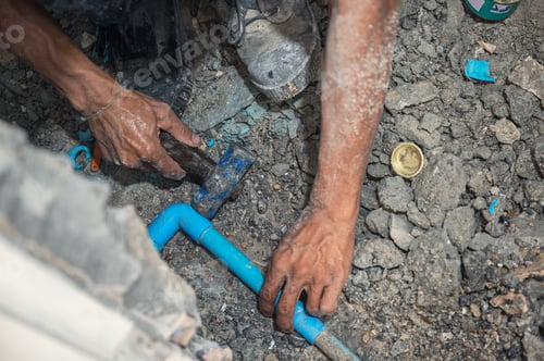 Preview: Plumber is hammering the PVC pipe installation in the bathroom