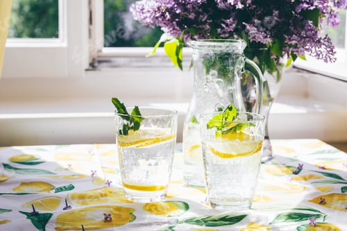 Preview: Two glasses with lemon soda on kitchen table
