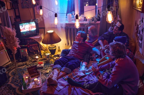 Preview: Friends watching TV at home