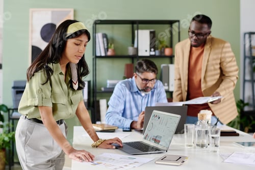 Preview: Working Professionals Collaborating on Project in Office Setting