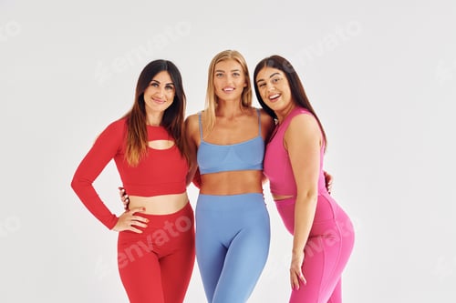 Preview: Positive mood. Beautiful women in sportive clothes is indoors in the studio