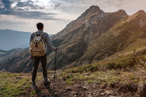 Preview: Young man standing on top of cliff mountains