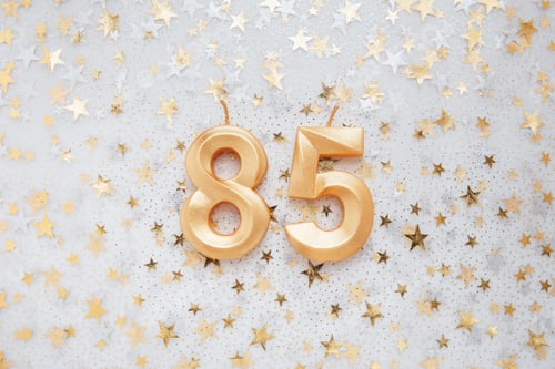 Preview: Number 55 fifty five golden celebration birthday candle on Festive Background.
