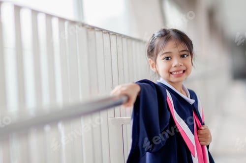 Preview: Happy Asian girls in graduation gowns on their graduation day at school.Graduation concept