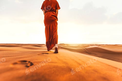 Preview: Arabian woman walk in the desert sand dunes at sunset - Wanderlust and summer vacation concept