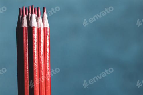 Preview: Red drawing pencils isolated over the gray background